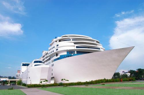 a large white building in front of a building at Pacific Palace Hotel in Nagoya