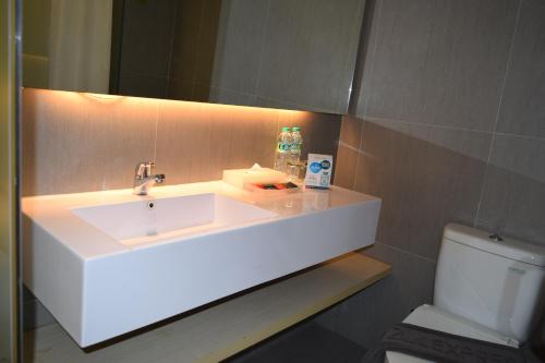 a bathroom with a sink and a toilet at Zuri Express Mangga Dua in Jakarta
