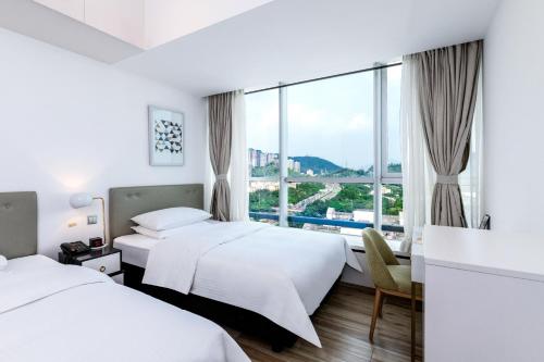 Postel nebo postele na pokoji v ubytování Golden Central Hotel Serviced Residence-Xin Hao E Du金中环服务公寓新浩e都店