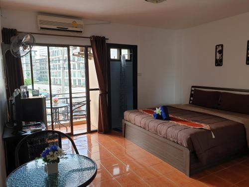 
a bedroom with a bed and a tv at Secrets - Pattaya in Pattaya Central
