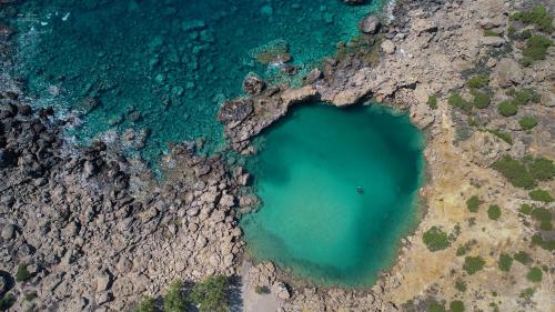 an aerial view of a pool of water in the ocean at Fairytale Elafonisi in Elafonisi