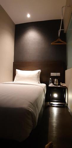 Ένα ή περισσότερα κρεβάτια σε δωμάτιο στο MIICO Hotel @ Mount Austin