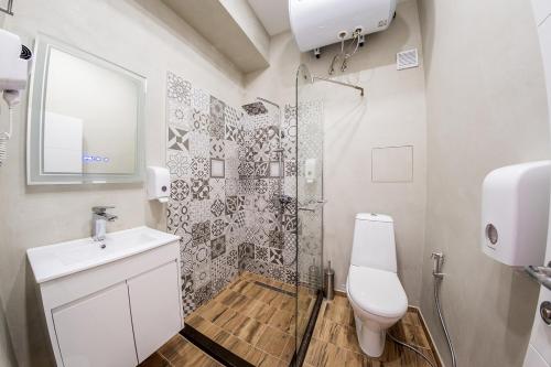 a bathroom with a shower and a toilet and a sink at Sofia Violet Life Apartment in Sofia