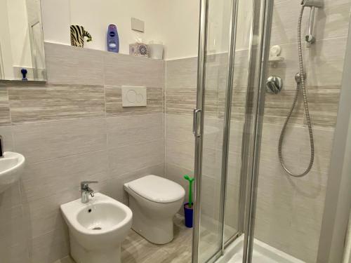a bathroom with a shower and a toilet and a sink at lungomare portoturistico in Chiavari