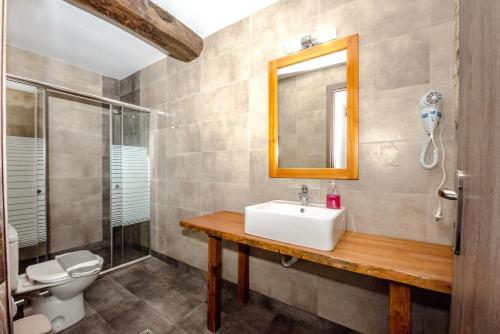 a bathroom with a sink and a toilet and a mirror at Fairytale Elafonisi in Elafonisi