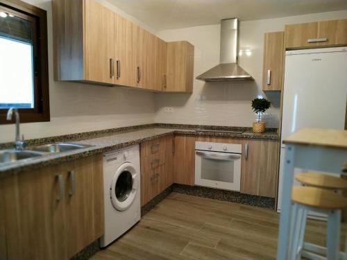 a kitchen with a washing machine and a sink at CASA EL REMANSO DE ZUHEROS in Zuheros