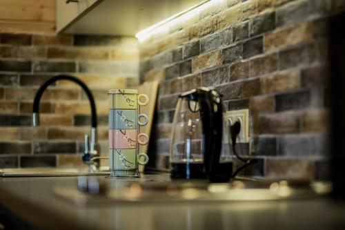 a kitchen counter top with a sink with affeepot and affeep at New Gudauri Loft2 #433 in Gudauri