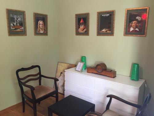 sala de estar con silla y cuadros en la pared en Apartament PIĘKNA, en Varsovia