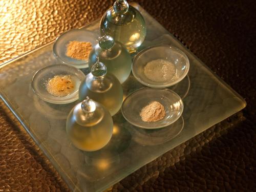 a glass tray with four bowls of food on it at The Legian Seminyak, Bali in Seminyak