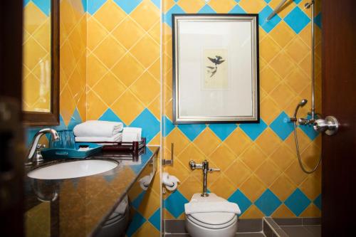 a bathroom with a toilet and a sink at Baboona Beachfront Living in Pattaya Central