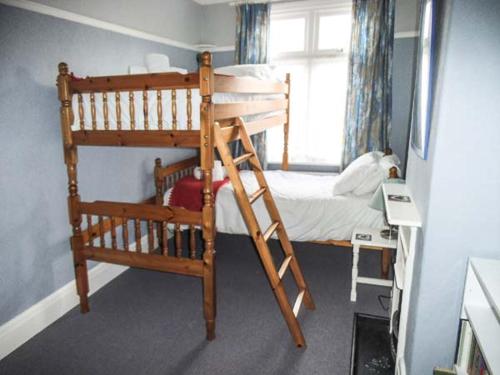 a bedroom with a bunk bed and a bunk ladder at Pendeen in Wadebridge