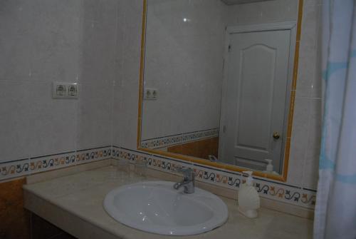 a bathroom with a sink and a mirror at Hotel Miramar in La Línea de la Concepción