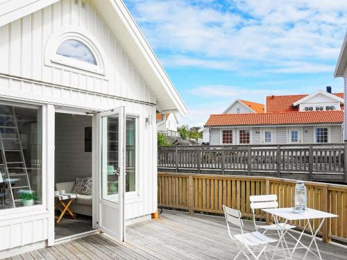 a patio with a table and chairs on a deck at 2 person holiday home in R nn ng in Rönnäng