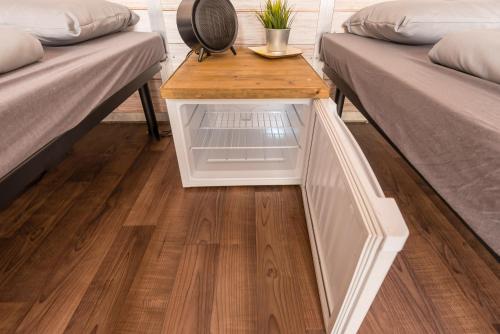 a small table in between two beds in a room at Oktoberfest Wiesn Camp Lodge in Munich