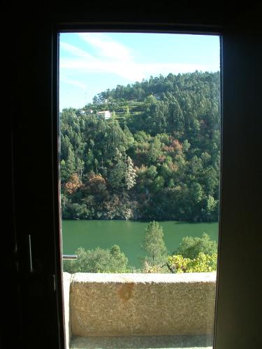 a view of a lake from a window at Casa de Gondomil in Alpendurada