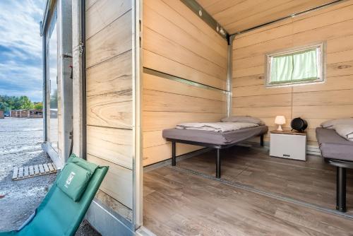 a small room with a bed and a window at Oktoberfest Wiesn Camp Lodge in Munich