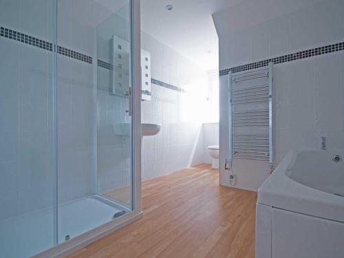 a bathroom with a glass shower and a sink at Chynoweth in Crantock