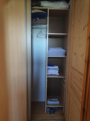 a walk in closet with a stainless steel refrigerator at gîte du bien être in Hodeng-Hodenger