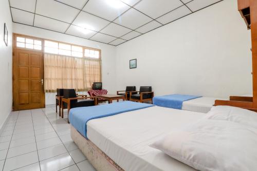 Ένα ή περισσότερα κρεβάτια σε δωμάτιο στο Satriafi Hotel