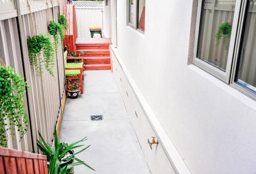 an empty hallway of a house with plants at U201 Brunswick Living Top floor Balcony Close to APT and CBD Free Wifi Tram at Doorstep in Melbourne