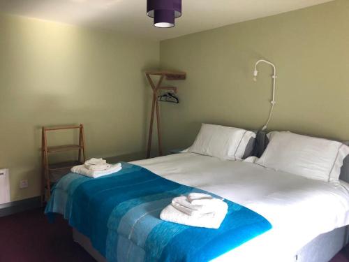 a bedroom with a bed with towels on it at Lady Charlotte's Loft in Schull