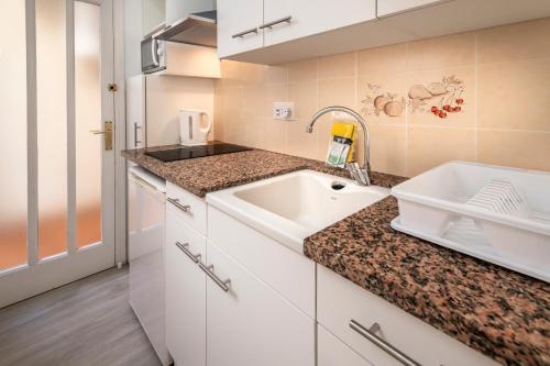 a kitchen with a sink and a counter at Apartments Sorrabona in Pineda de Mar