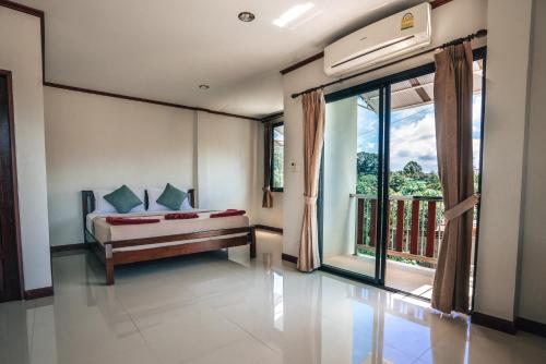 En eller flere senge i et værelse på Phra Ae Apartments