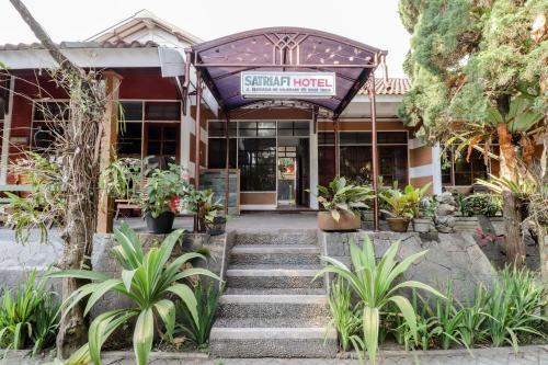 a building with a sign that reads sinful house at Satriafi Hotel in Kaliurang