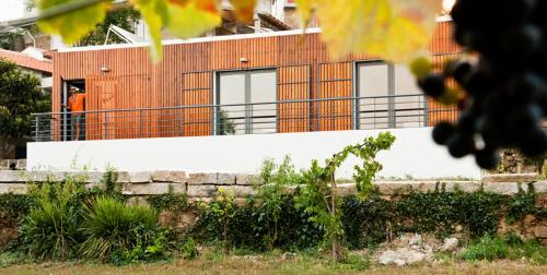 a man standing on a fence in front of a building at Casa de Vila Cete in Alpendurada