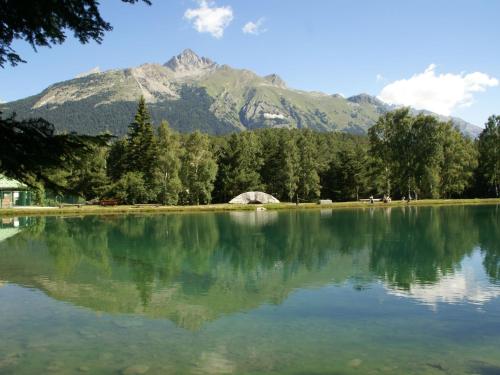 a large lake with a mountain in the background at Chalet in La Norma near Ski Lift in Villarodin-Bourget