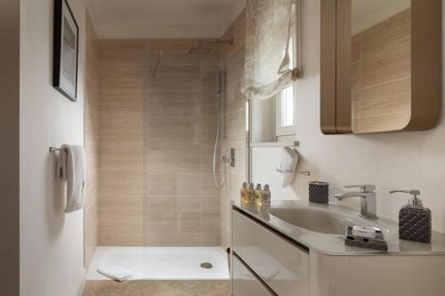 a bathroom with a sink and a shower at Villa Cleo in Vabriga