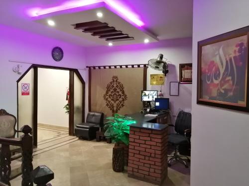 an office with purple lights on the ceiling at Seaview Lodge Guest House in Karachi