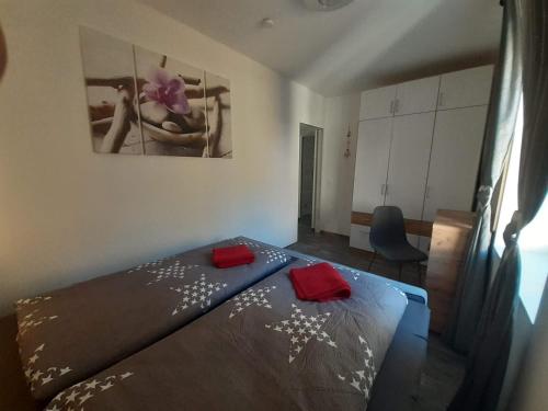 a bedroom with a bed with red towels on it at Haus Renè in Villach