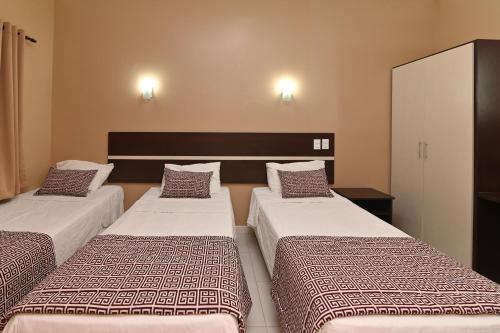 Llit o llits en una habitació de Hotel São Bento