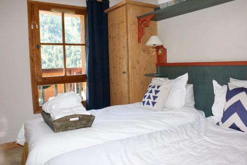 a bedroom with two beds and a window at Arc 1950 Apartment - Sources de Marie, Mountain View in Arc 1950