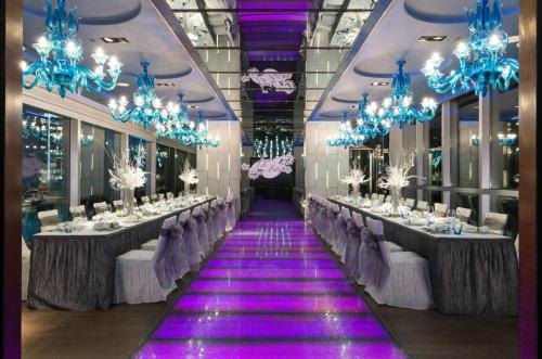 a banquet hall with long tables and blue chandeliers at Crowne Plaza Hong Kong Causeway Bay by IHG in Hong Kong