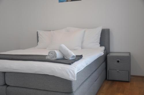 a bed with two towels sitting on top of it at 4 Beds and More Vienna Apartments - Contactless check-in in Vienna