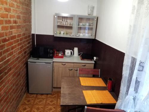 a small kitchen with a table and a refrigerator at "MARKIZAS" Karaimu 25 in Trakai