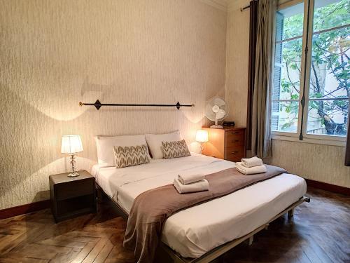 a bedroom with a large bed and a window at Nestor&Jeeves - DALPOZZO GRANDE - Central - Close beaches in Nice