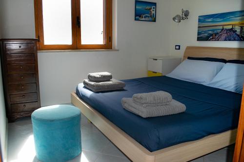 a bedroom with a bed with towels on it at Beach House Acquamarina in Letojanni