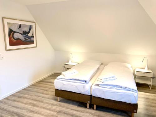 ein Schlafzimmer mit einem Bett und zwei Lampen an zwei Tischen in der Unterkunft Ferienwohnung Bad Saarow in Bad Saarow