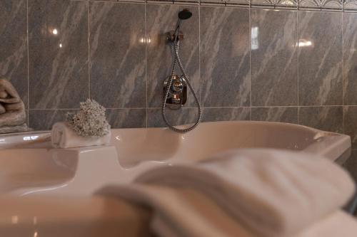 a bathroom with a bath tub with a shower at A Casinha in Vila Nova de Famalicão