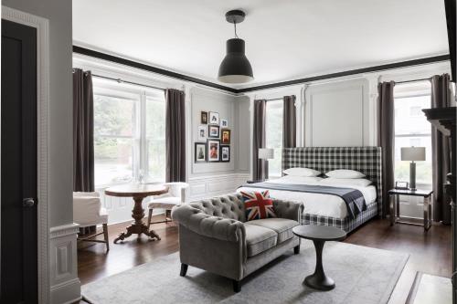 a bedroom with a bed and a couch at The George in Montclair