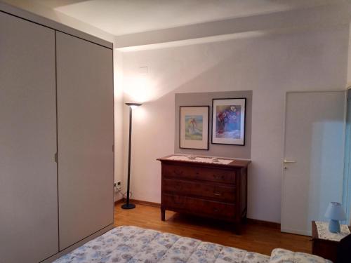 a bedroom with a bed and a dresser and a lamp at A due passi in Arezzo