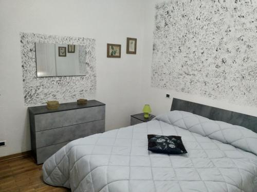 a bedroom with a bed and a dresser and a mirror at A due passi in Arezzo