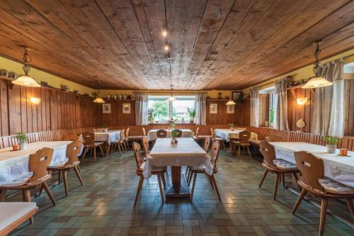 a restaurant with wooden walls and tables and chairs at Gasthof Zur Seeburg in Seekirchen am Wallersee