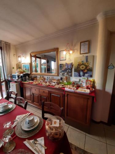 a kitchen with a table and a counter with food at B&B L'Isola di Casa in Brembate