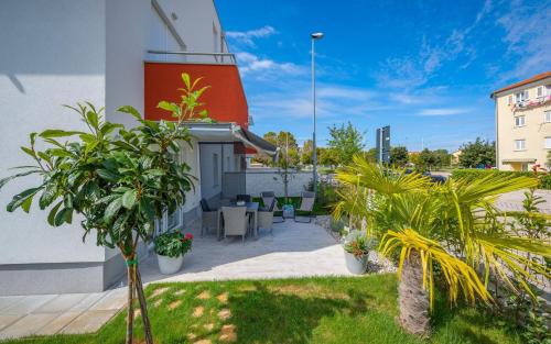 a courtyard of a building with plants in a yard at SOFIA house with apartment in Umag