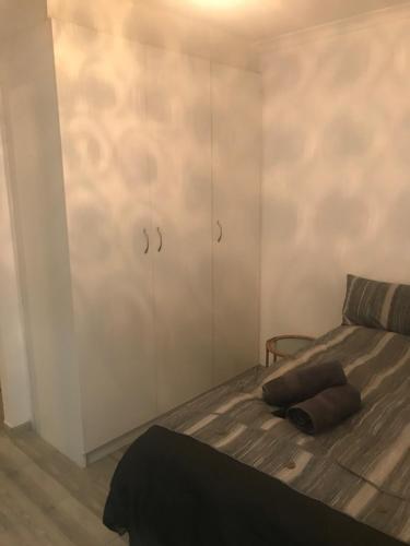 a bedroom with a bed and a cabinet at Modern secure apartment in Strand - Little Greece in Strand