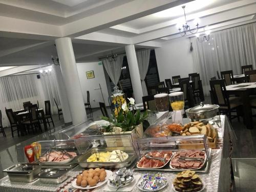 a buffet with many different types of food on a table at Vila FAN Confort in Vişeu de Sus